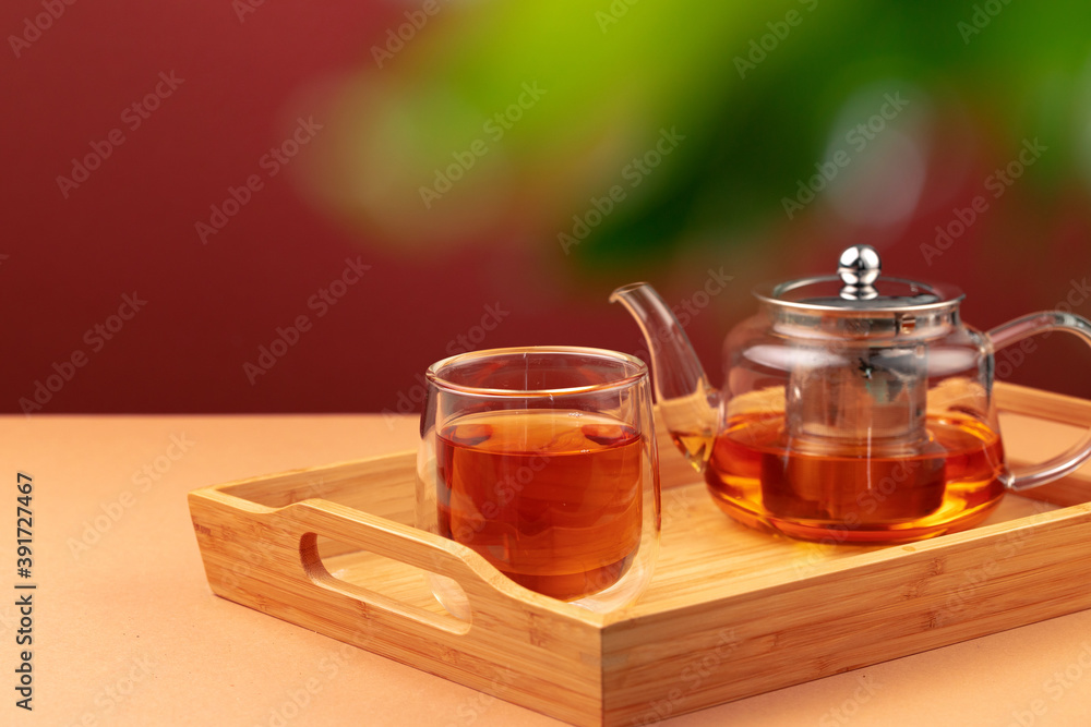 Glass teapot and cup with black tea Glass teapot and cup with black tea