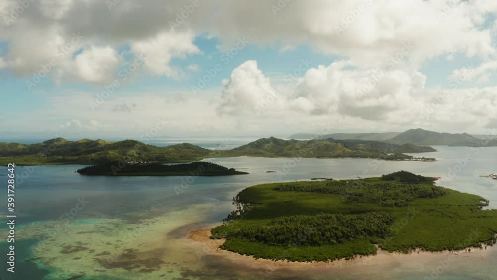 Aerial view of blue sea with atoll, islands and coral reef against the sky and clouds. Bucas grande, Philippines. Aerial view of blue sea with atoll, islands and coral reef against the sky and clouds. Bucas grande, Philippines.