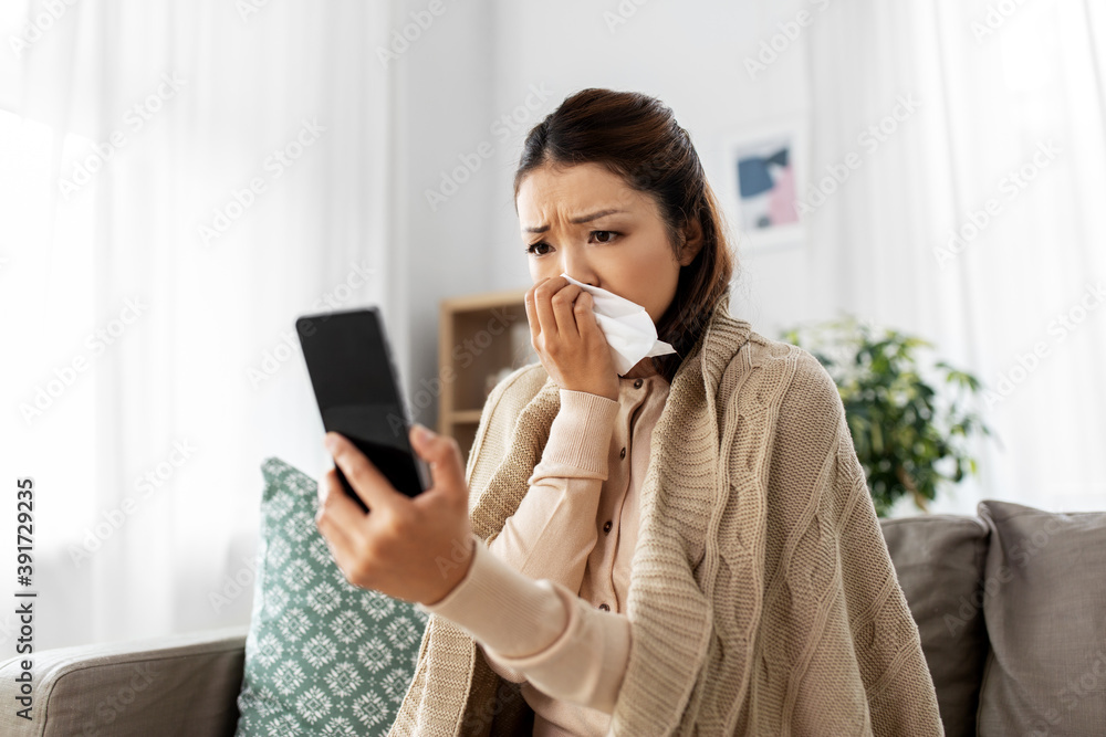 © Syda Productions - medicine, healthcare and technology concept - sick young asian woman having video call or online consultation on smartphone at home