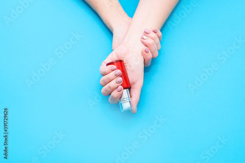 Beautiful woman's hands on the pink background. Well-groomed female hands with a beautiful manicure
