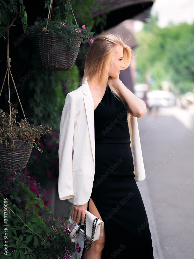 Elegant blonde girl posing on the street