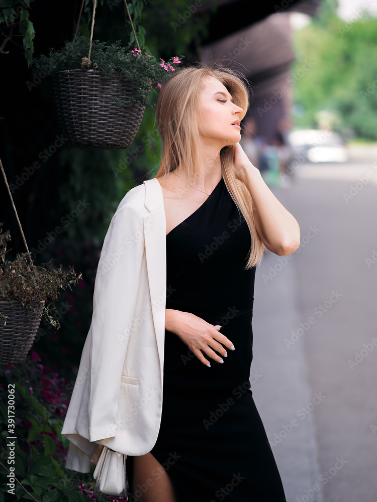 Elegant blonde girl posing on the street