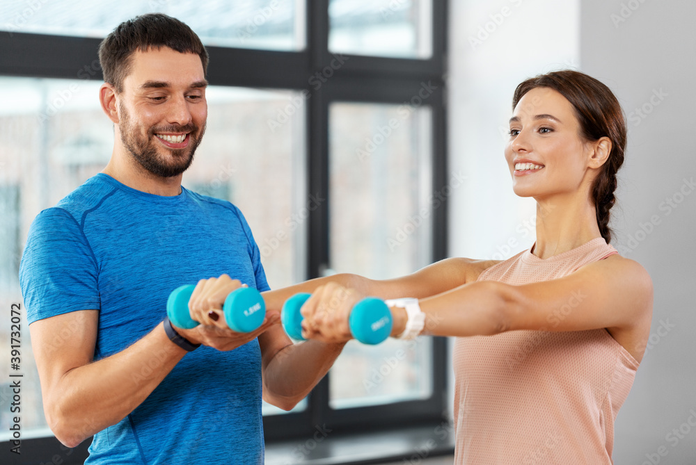 sport, fitness, lifestyle and people concept - smiling man and woman exercising with dumbbells at home sport, fitness, lifestyle and people concept - smiling man and woman exercising with dumbbells at home