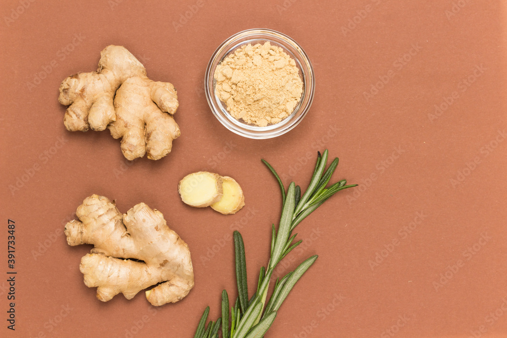 Raw ginger root and dry ginger on brown