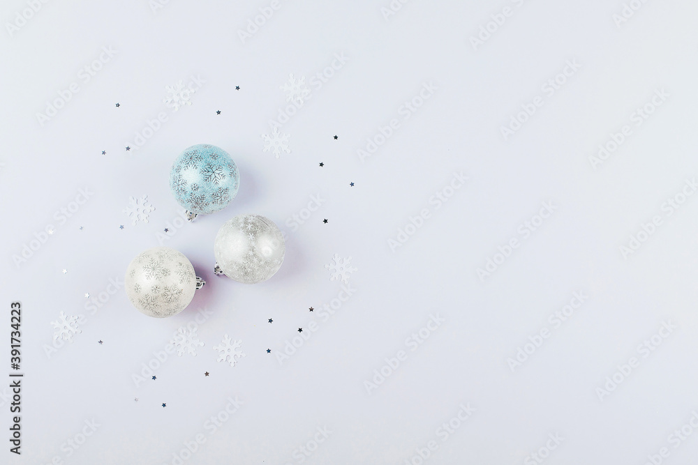 Silver confetti and christmas balls on background. Flat lay, top , copy space, holiday background.