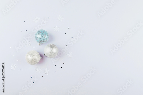 Silver confetti and christmas balls on background. Flat lay  top   copy space  holiday background.