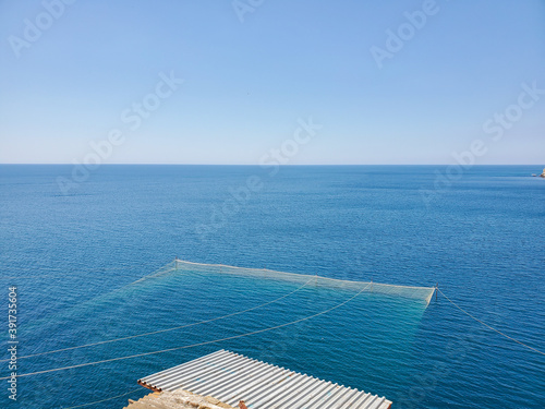 top view, fishing net in sea water. Fishing nets in the sea on a Sunny day.