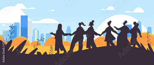 girls silhouettes standing together female empowerment movement women's community union of feminists concept cityscape background horizontal full length vector illustration
