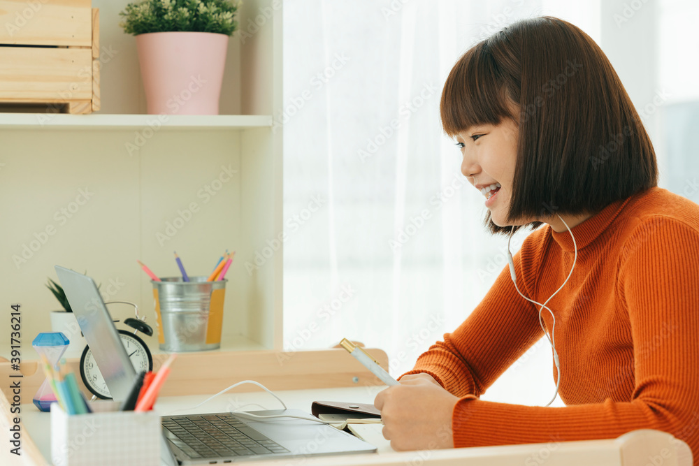 Beautiful young asian thai black short hair woman learning from home study online on laptop and wearing earphone. Beautiful young asian thai black short hair woman learning from home study online on laptop and wearing earphone.
