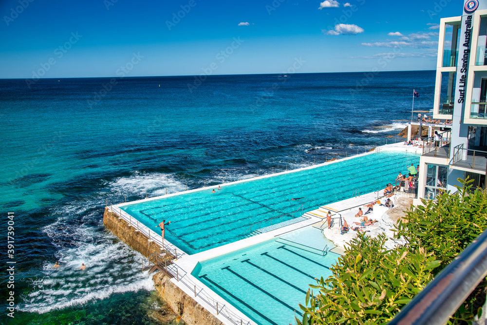 BONDI BEACH, AUSTRALIA - AUGUST 18, 2018: Tourists and locals enjoy Iceberg Pools on a wonderful sunny day