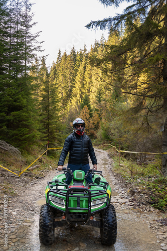 A man on a quad bike in the mountains. 