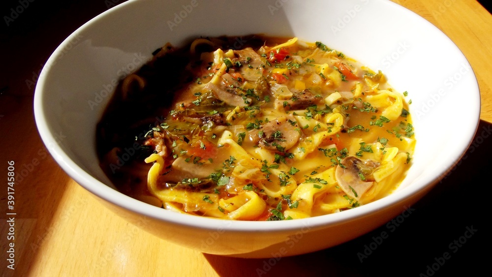 autumn soup with vegetables and Italian pasta. hot meal in round bowl with front view