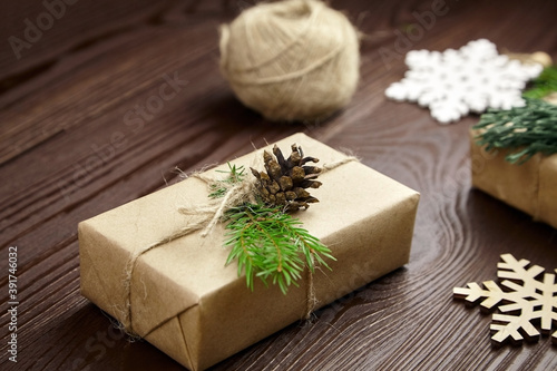 Christmas gift box with decorations wrapped in craft paper
