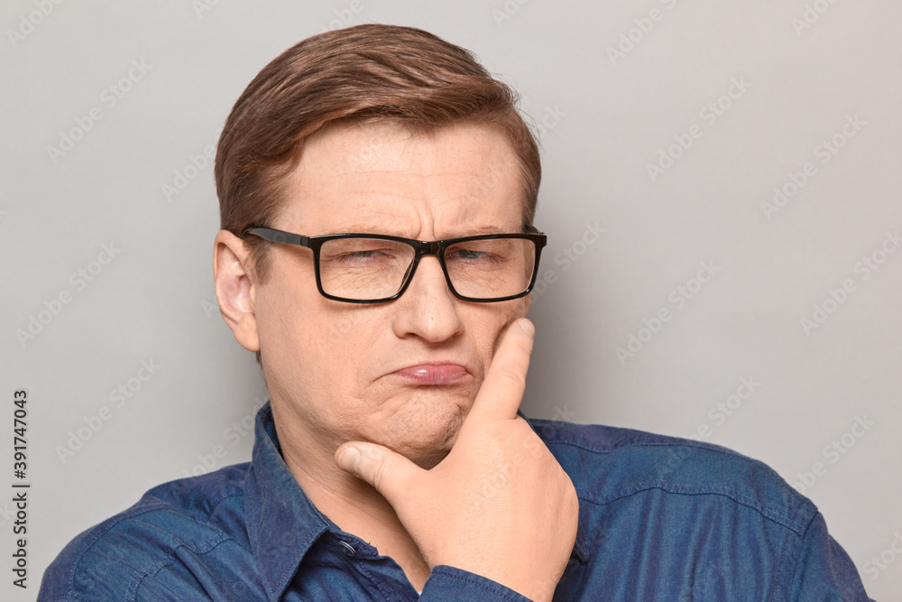 Portrait of funny thoughtful blond mature man with glasses Portrait of funny thoughtful blond mature man with glasses