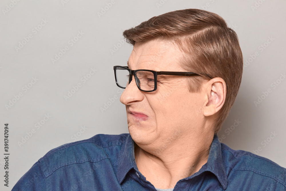 Portrait of disgruntled man grimacing from displeasure and disgust Portrait of disgruntled man grimacing from displeasure and disgust