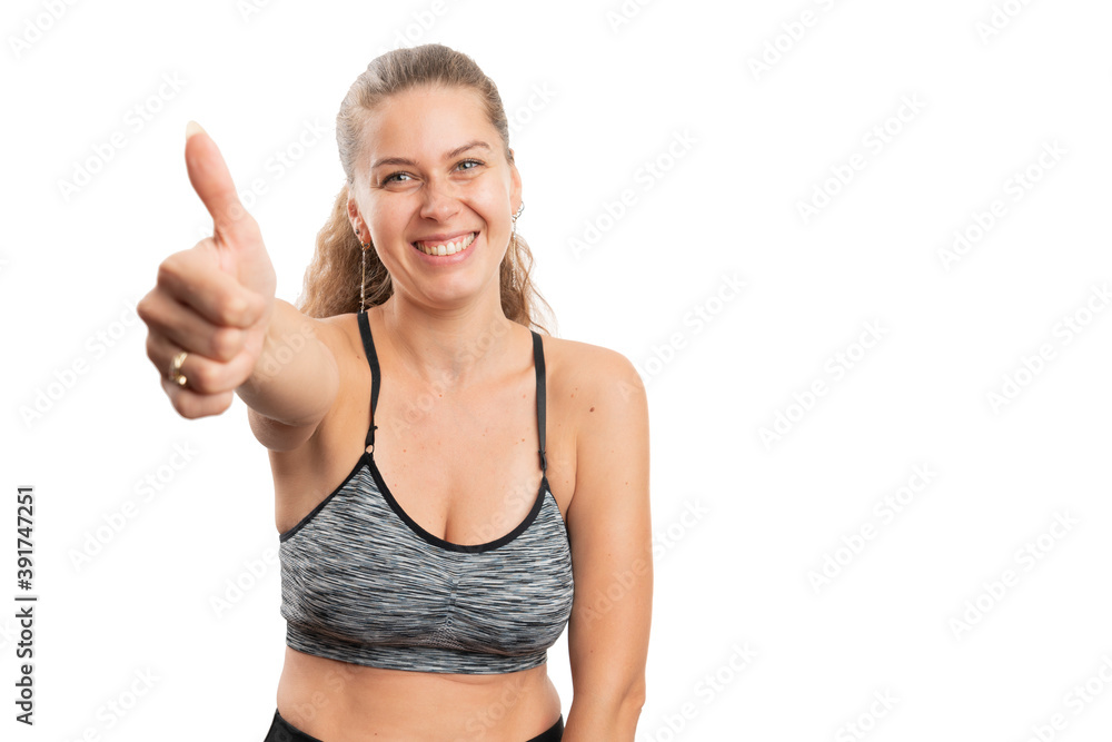 Woman wearing gym attire making like gesture with copyspace Woman wearing gym attire making like gesture with copyspace