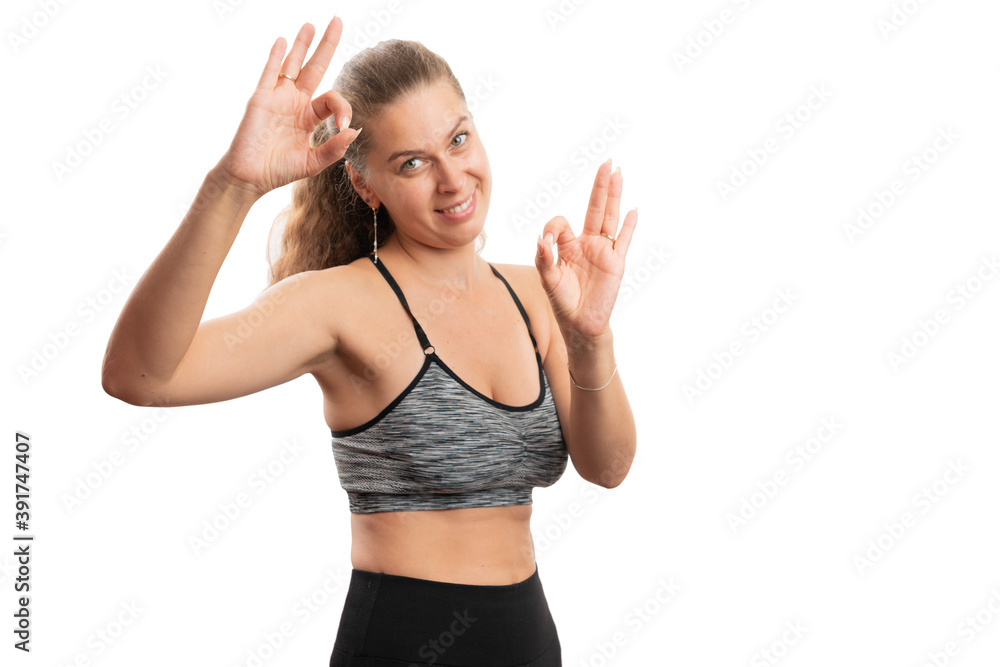 Model showing double okay gesture in sports attire with copyspace Model showing double okay gesture in sports attire with copyspace