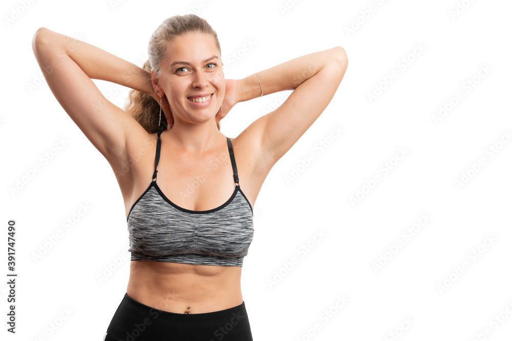 Fototapeta premium Fit sporty woman showing abdomen smiling with blank copyspace