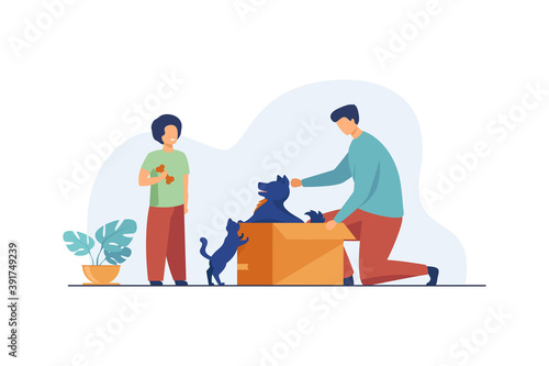 Dad and son adopting pets. Man opening box with dog, kid, cat flat vector illustration. Animals care, pet adoption concept for banner, website design or landing web page