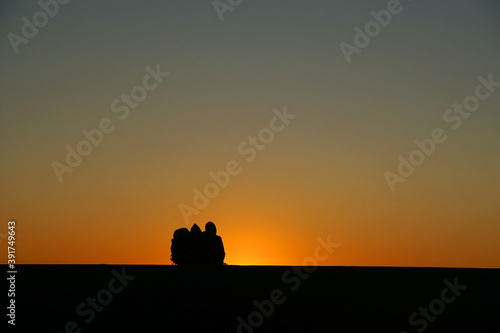 Silhouette man on the rooftop with orange sky sunset over the ocean at san francisco united states USA - beautiful natural texture background 