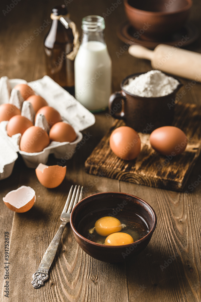 ingredients for baking, raw eggs in the bowl. ingredients for baking, raw eggs in the bowl.
