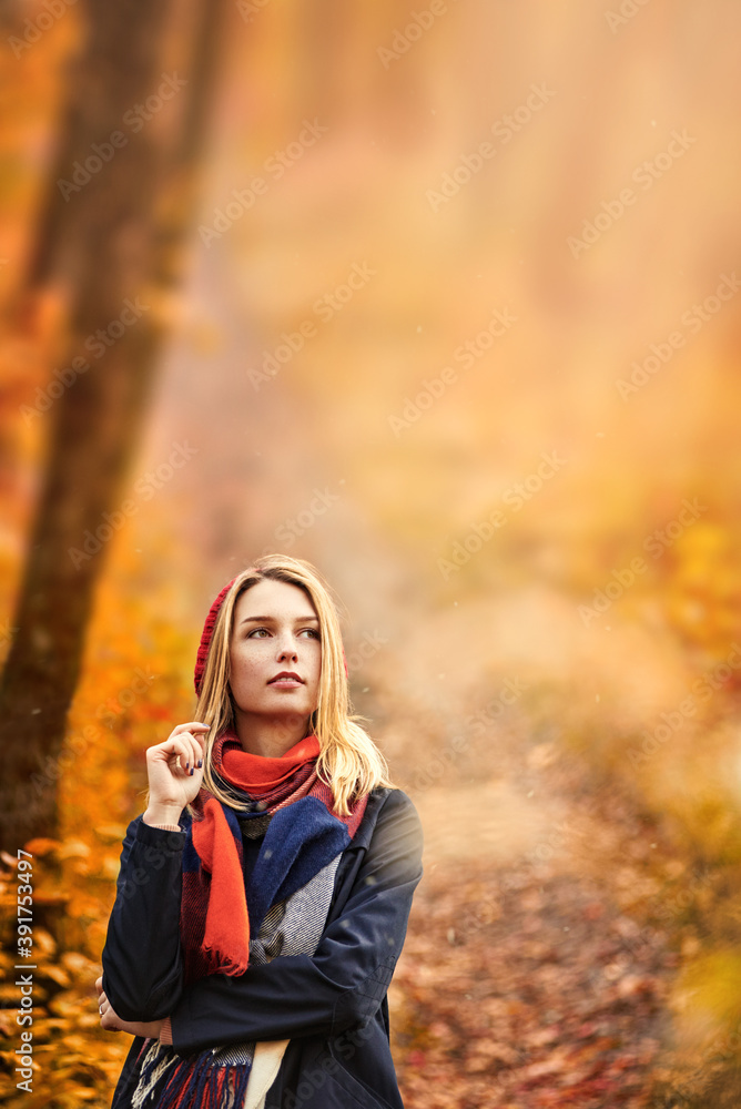 Blonde happy girl in good mood posing in autumn park with art retouch Blonde happy girl in good mood posing in autumn park with art retouch