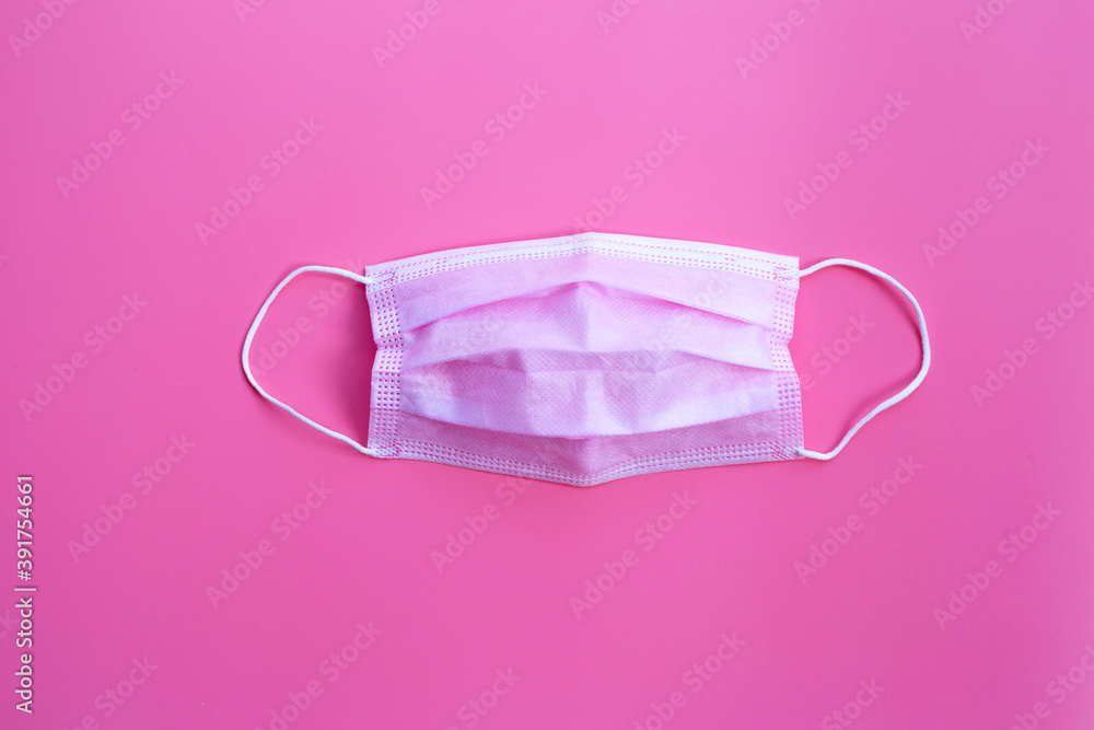 Pink protective medical mask on pink background. Top view Pink protective medical mask on pink background. Top view