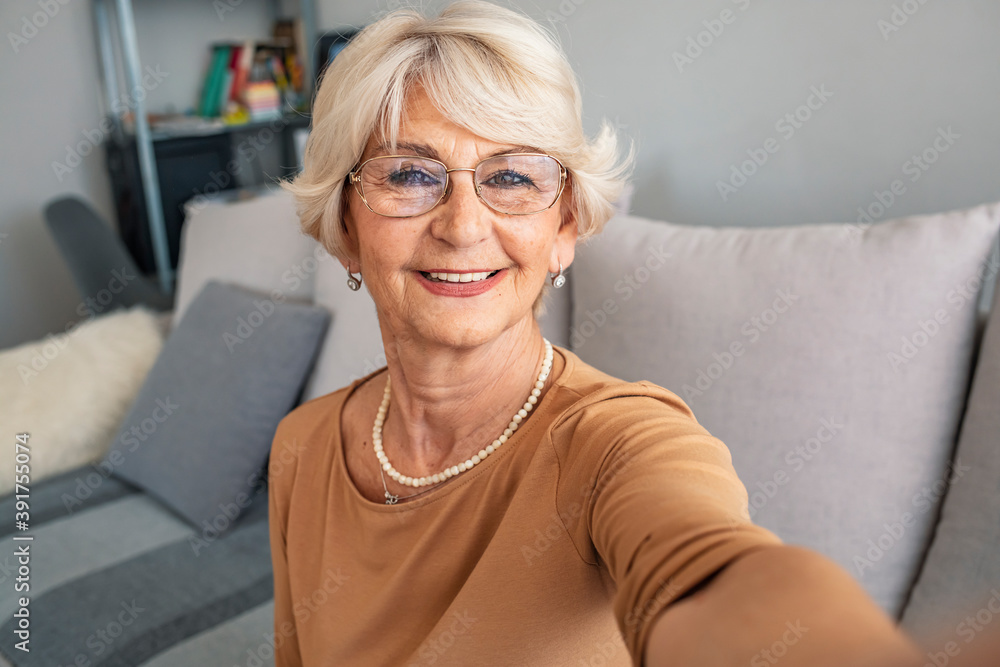 Grandma Taking Selfies at Home in the Livingroom. Close Up Portrait of