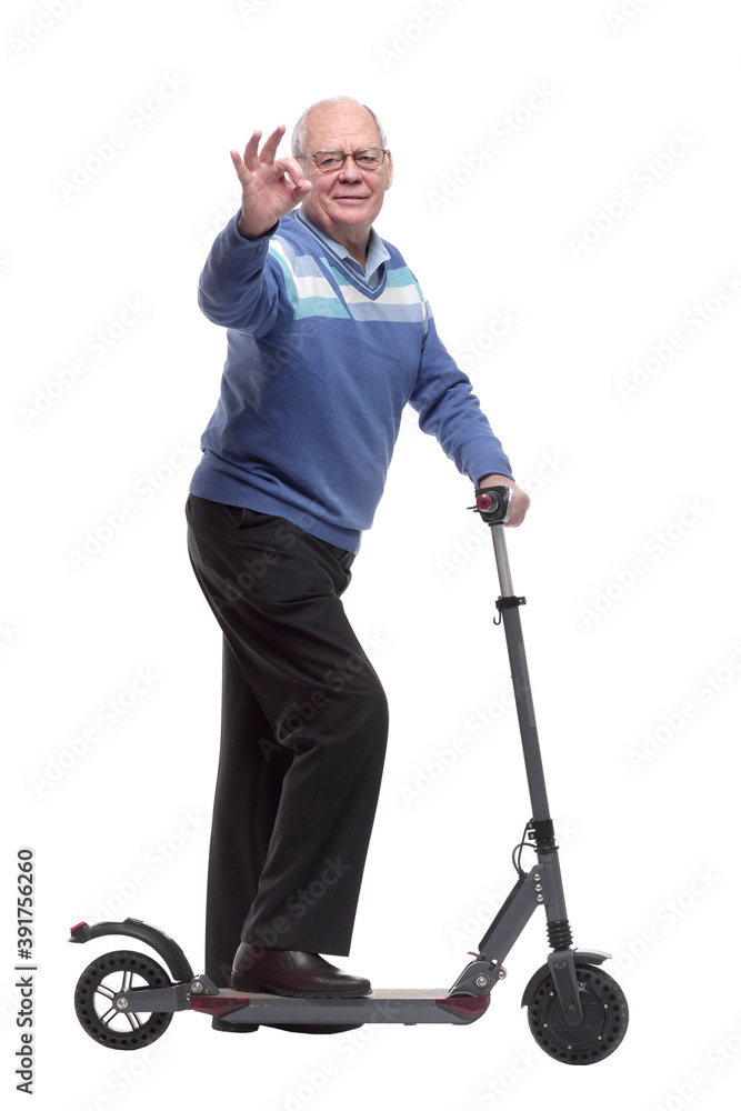 side view. an elderly man with an electric scooter pointing at you side view. an elderly man with an electric scooter pointing at you