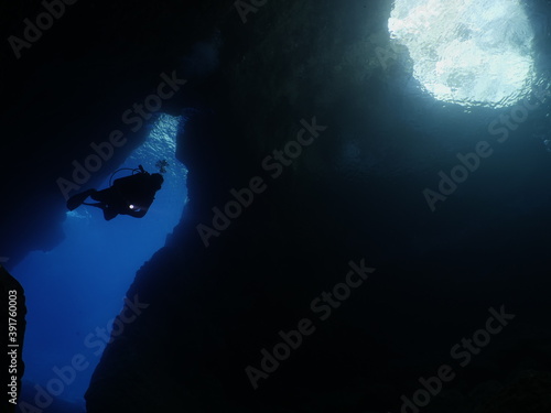scuba divers enjoying the topography and fauna underwater ocean scenery 