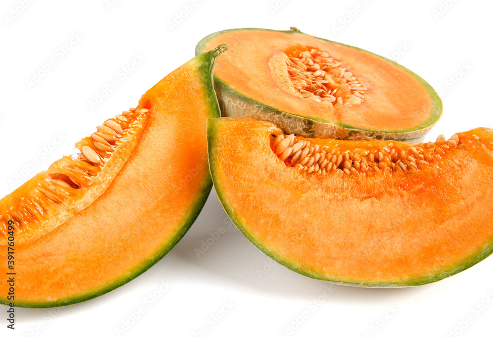 Half of the cantaloupe melon and a piece of melon are isolated on a white background. Half of the cantaloupe melon and a piece of melon are isolated on a white background.