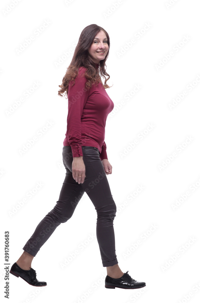 in full growth. happy young woman striding forward in full growth. happy young woman striding forward
