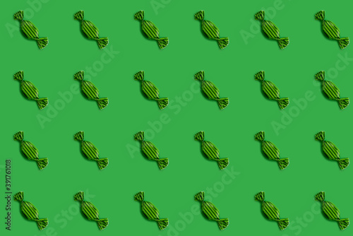 repeating collage of green candy on green background, flat lay composition, seamless pattern,