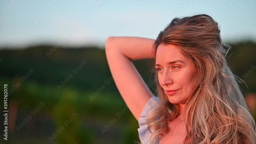 Happy blonde woman dancing at sunset Happy blonde woman dancing at sunset