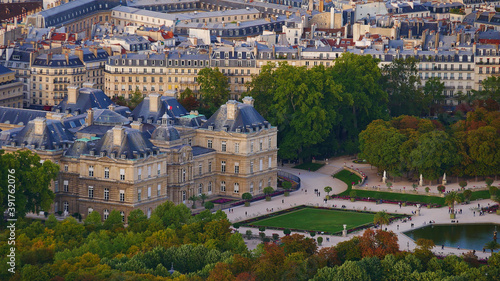 Closeup aerial view of famous Luxembourg Palace located in the garden area Jardin du Luxembourg in the historic center in Paris, France with beautiful discolored trees in autumn season.