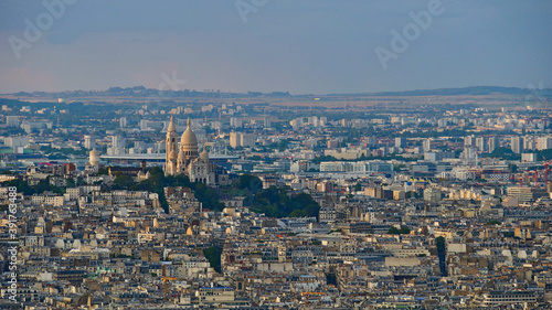 Closeup aerial panorama view of Montmartre hill in the north of the historic center of Paris, France with famous white colored cathedral Sacre-Coeur in the evening light.