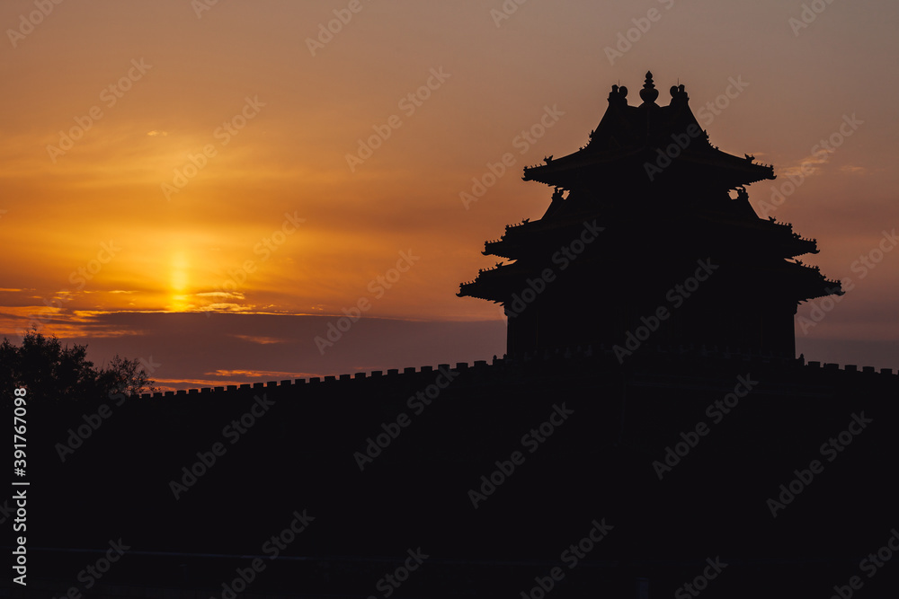 Сhinese pagoda silhouette in front of scenic colorfull sunrise