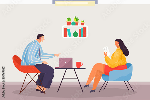 Business meeting or working process in the head office. Woman boss sitting on chair reading document, talking to man manager. Project management and teamwork concept. Businesswoman checks new contract