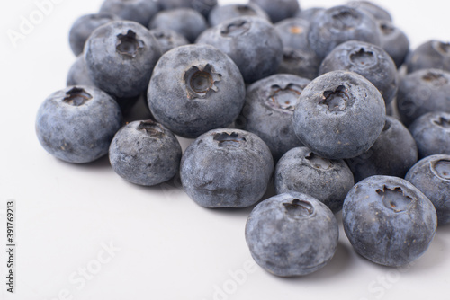Berry background. Fresh berry blueberries on a white background. Concept of healthy and diet food. Flat lay, top view, Ripe blueberries with copy space for text, shallow DOF