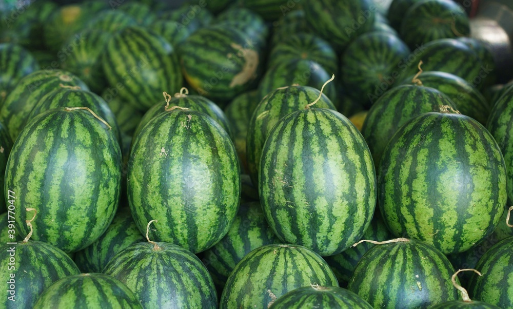 Close up a a lot of a watermelons.