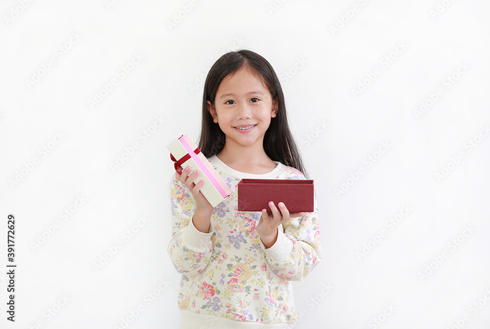 Happy asian little girl while open gift box on white background. Happy new year and Merry christmas concept Happy asian little girl while open gift box on white background. Happy new year and Merry christmas concept