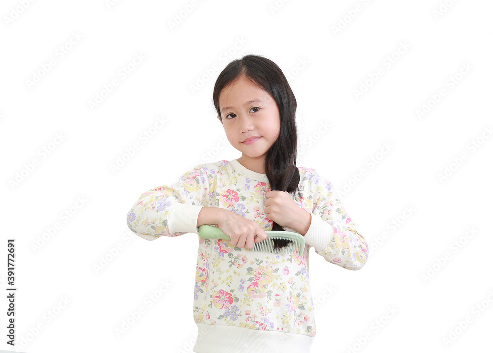 Beautiful asian little kid girl combing long hair isolated on white background. Hair care concept Beautiful asian little kid girl combing long hair isolated on white background. Hair care concept