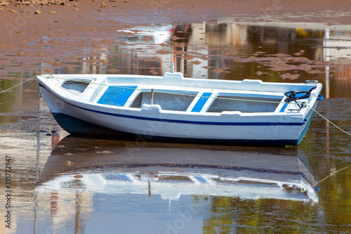 Boat into the sea during low tide in Nea Artaki, Euboea / Greece . Sunny summer day photo