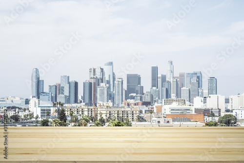 Blank table top made of wooden planks with beautiful Los Angeles cityscape at daytime on background  mockup