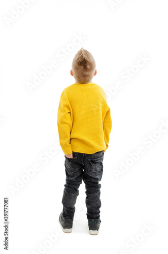 Back view of little boy looking at wall. Rear view. Isolated on white background 