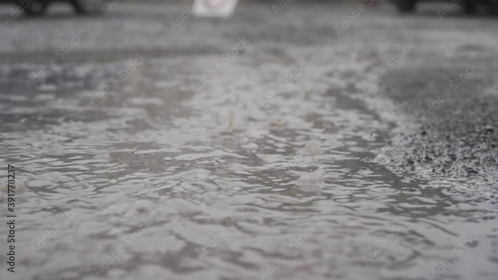 Close-up shot of dirty water on the ground during rain. Footage. Close-up shot of dirty water on the ground during rain. Footage.