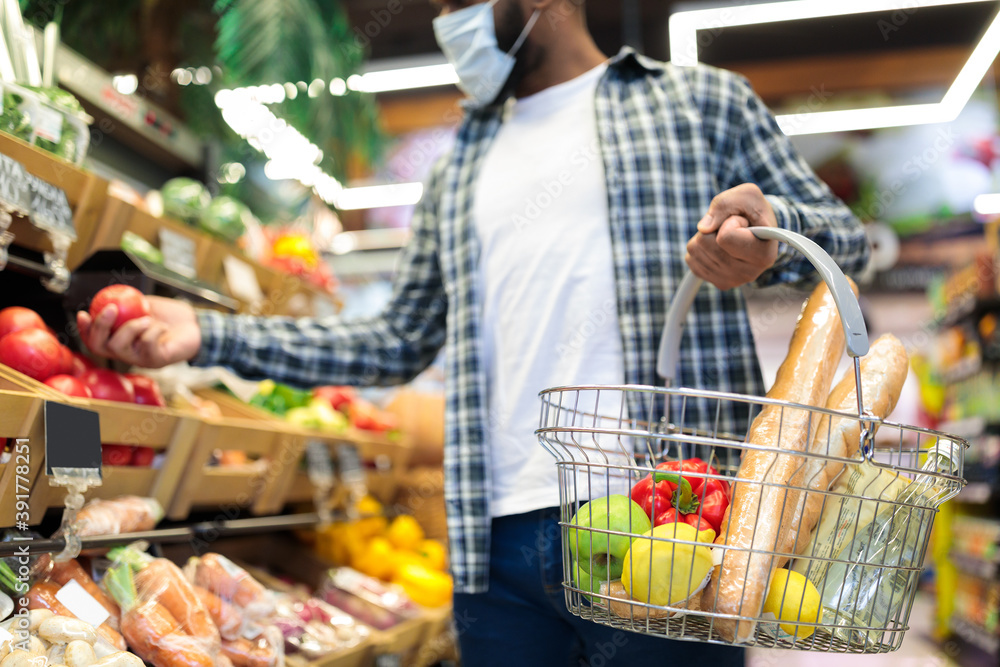 Unrecognizable Black Guy Buying Vegetables In Supermarket Standing In Store