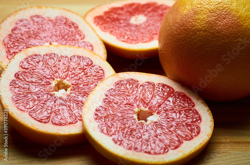juicy grapefruit slices close up on a board