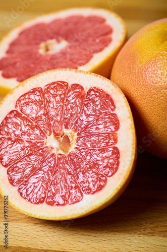 juicy grapefruit slices close up on a board vertically
