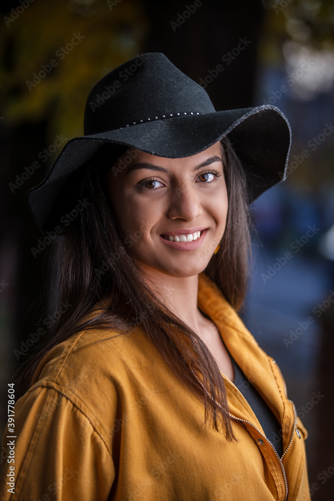 Beautiful young woman laying and smiling on the oak and maple leaves in the park. Beautiful young woman laying and smiling on the oak and maple leaves in the park.